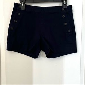 Navy blue button shorts.
